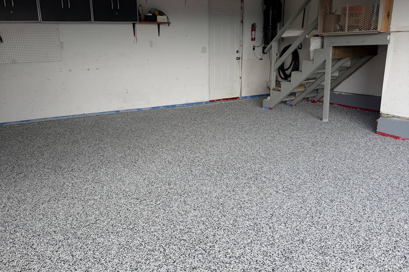 Decorative flake epoxy garage floor installation with flakes broadcast to refusal